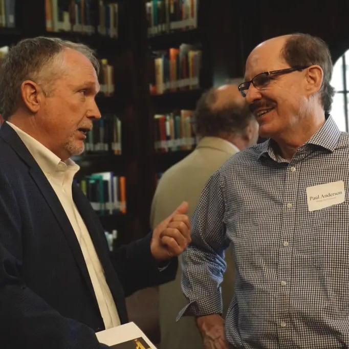 Two men in conversation at an event