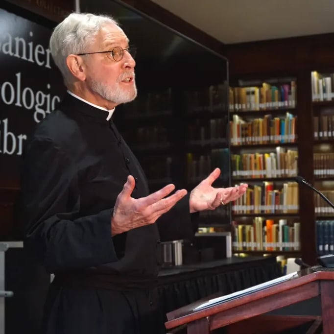 Man speaking at podium in library